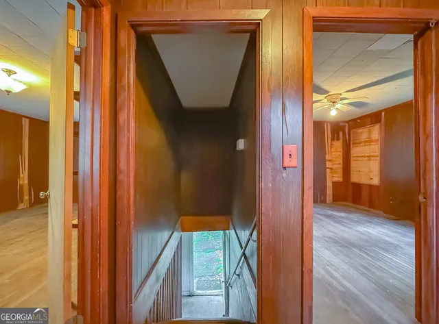 a view of an empty room with glass door and a window