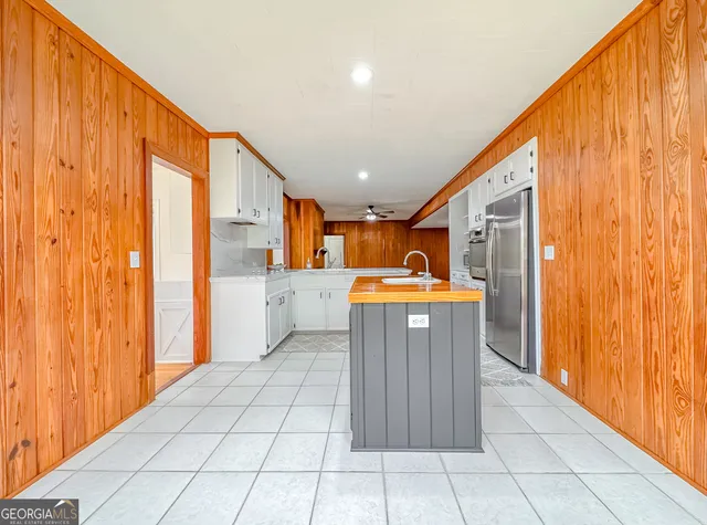 a view of a livingroom with furniture wooden floor and windows