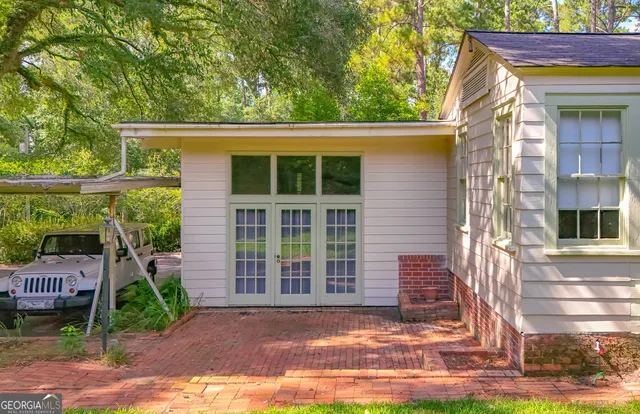 a aerial view of a house with a yard and potted plants