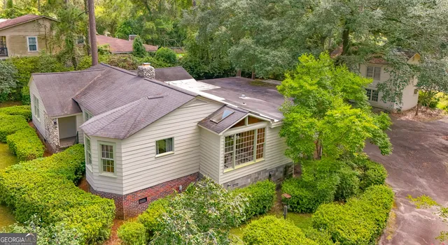 a view of a yard with a table and chairs and a large tree