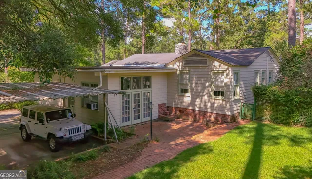 a view of a house with backyard porch and sitting area