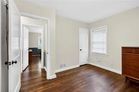 an empty room with wooden floor and a window