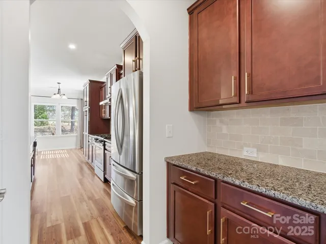 a kitchen with granite countertop a refrigerator and a sink