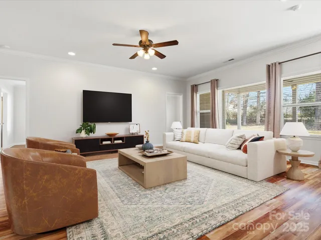 a living room with furniture and a flat screen tv