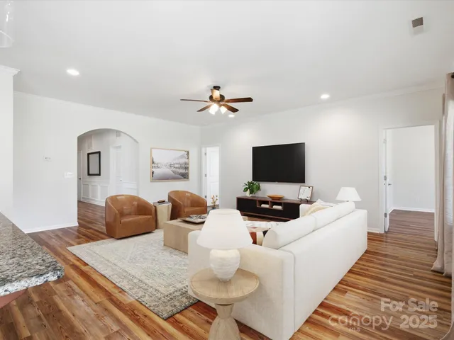 a bedroom with furniture and a flat screen tv