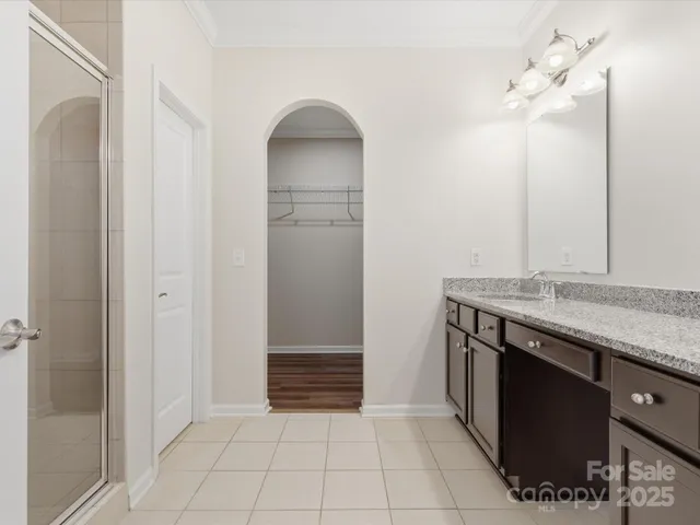 a bathroom with a glass shower door