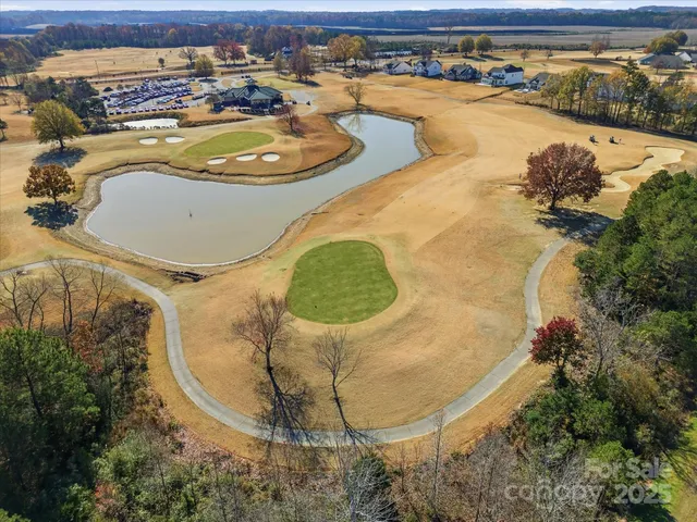 an aerial view of a house with a yard basket ball court and outdoor seating