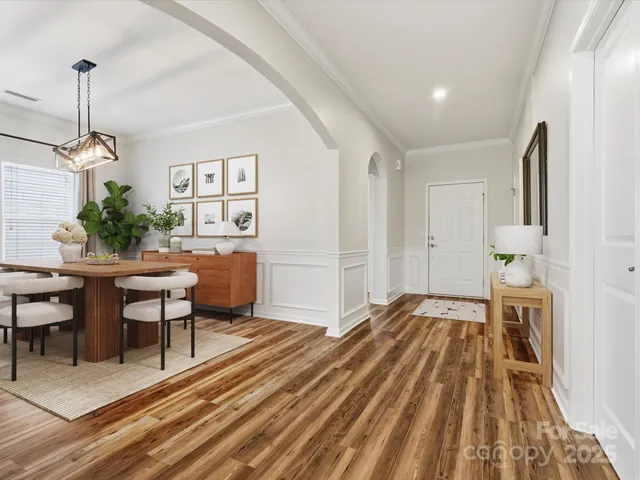 a bedroom with furniture and a wooden floor
