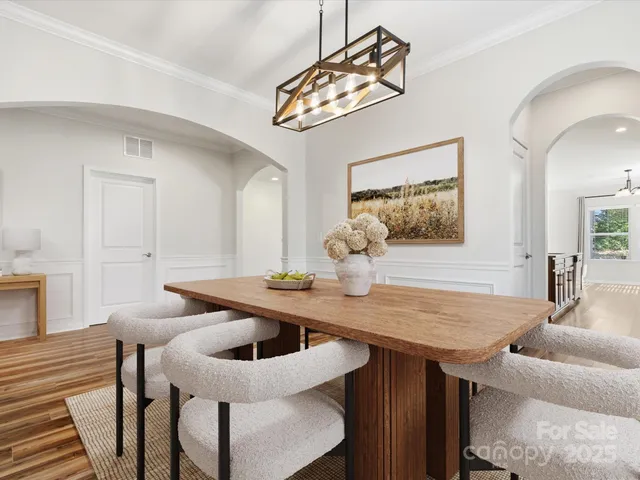 a view of a dining room with a table and chairs