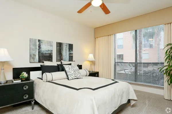 a bedroom with a bed and window