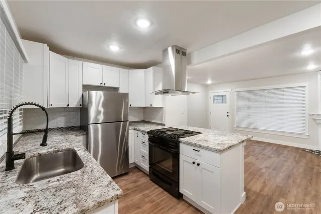 a kitchen with a sink stove and refrigerator