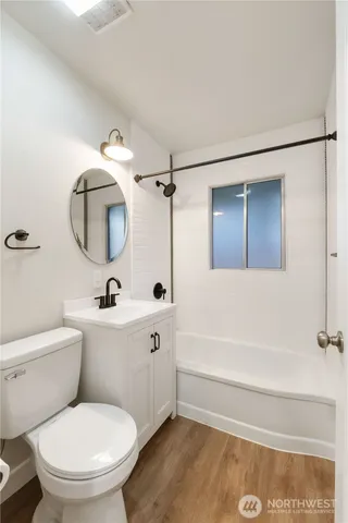 a bathroom with a toilet and a tub