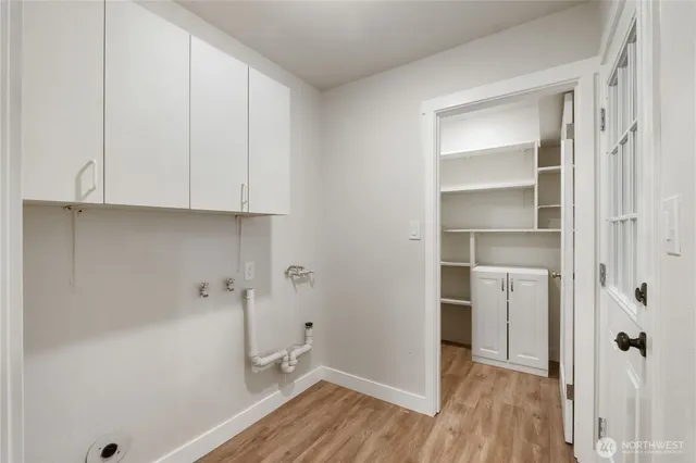 a view of bathroom with a sink and wooden floor
