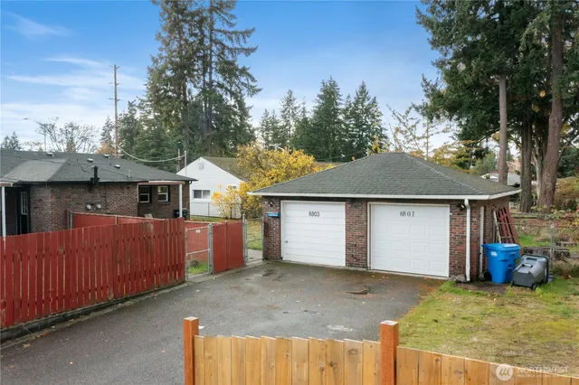 a view of a house with a garage and yard