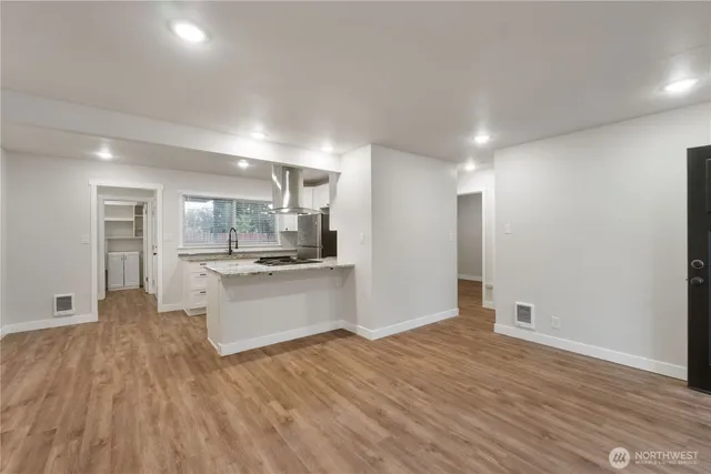 a view of kitchen with wooden floor