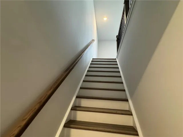 a view of a room with wooden floor and staircase