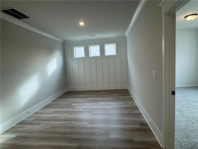 a view of an empty room and wooden floor