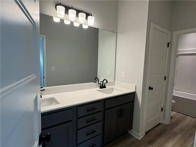a bathroom with a double vanity sink and mirror