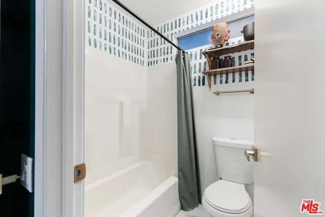 a bathroom with a bathtub and a toilet