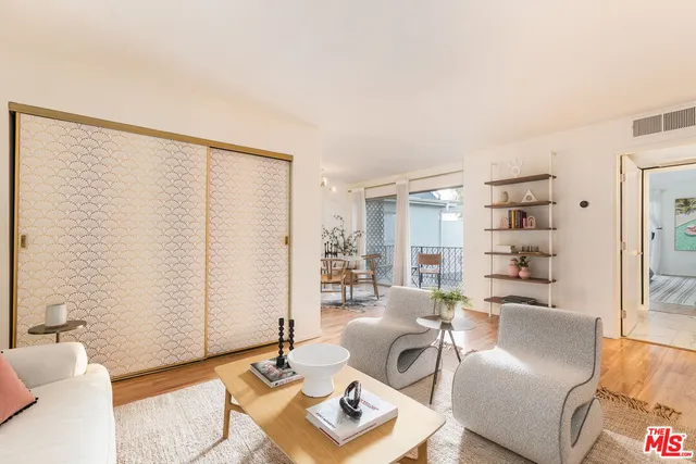 a living room with furniture and next to a window