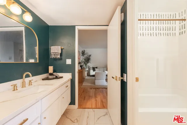 a en suite bathroom with a sink and mirror