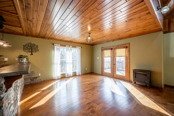 a view of empty room with wooden ceiling