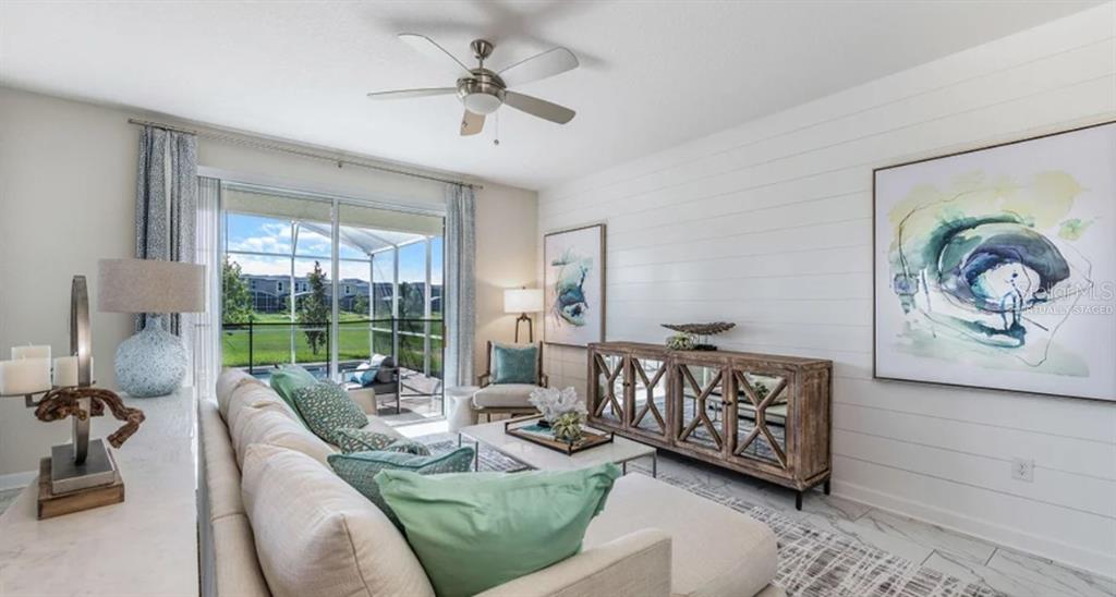 7855 Poplin Street Kissimmee, FL 34747 - Photo 4 of 15 a living room with furniture and a large window