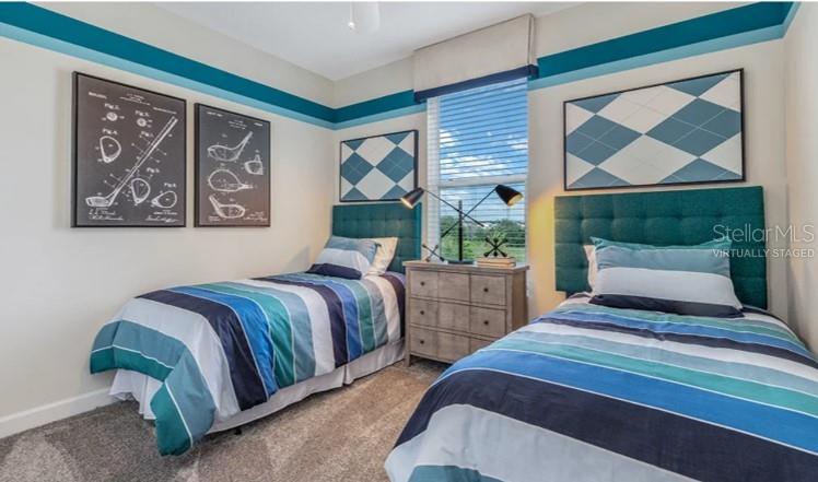 7855 Poplin Street Kissimmee, FL 34747 - Photo 6 of 15 a bedroom with two beds and a painting on the wall