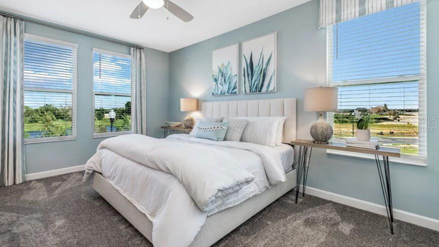 7855 Poplin Street Kissimmee, FL 34747 - Photo 9 of 15 a bed sitting in a bedroom next to a window