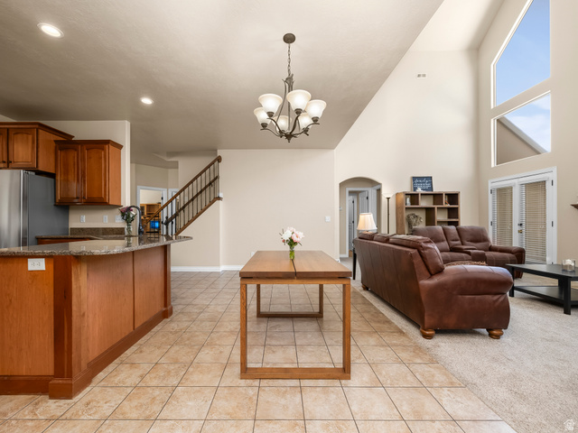 255 East 1200 North Mapleton, UT 84664 - Photo 5 of 37 Open-concept living space featuring a two-story vaulted ceiling and expansive windows