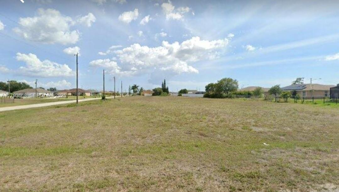 2710 Northwest 7th Place Cape Coral, FL 33993 - Photo 1 of 3 a view of a lake with houses in the background