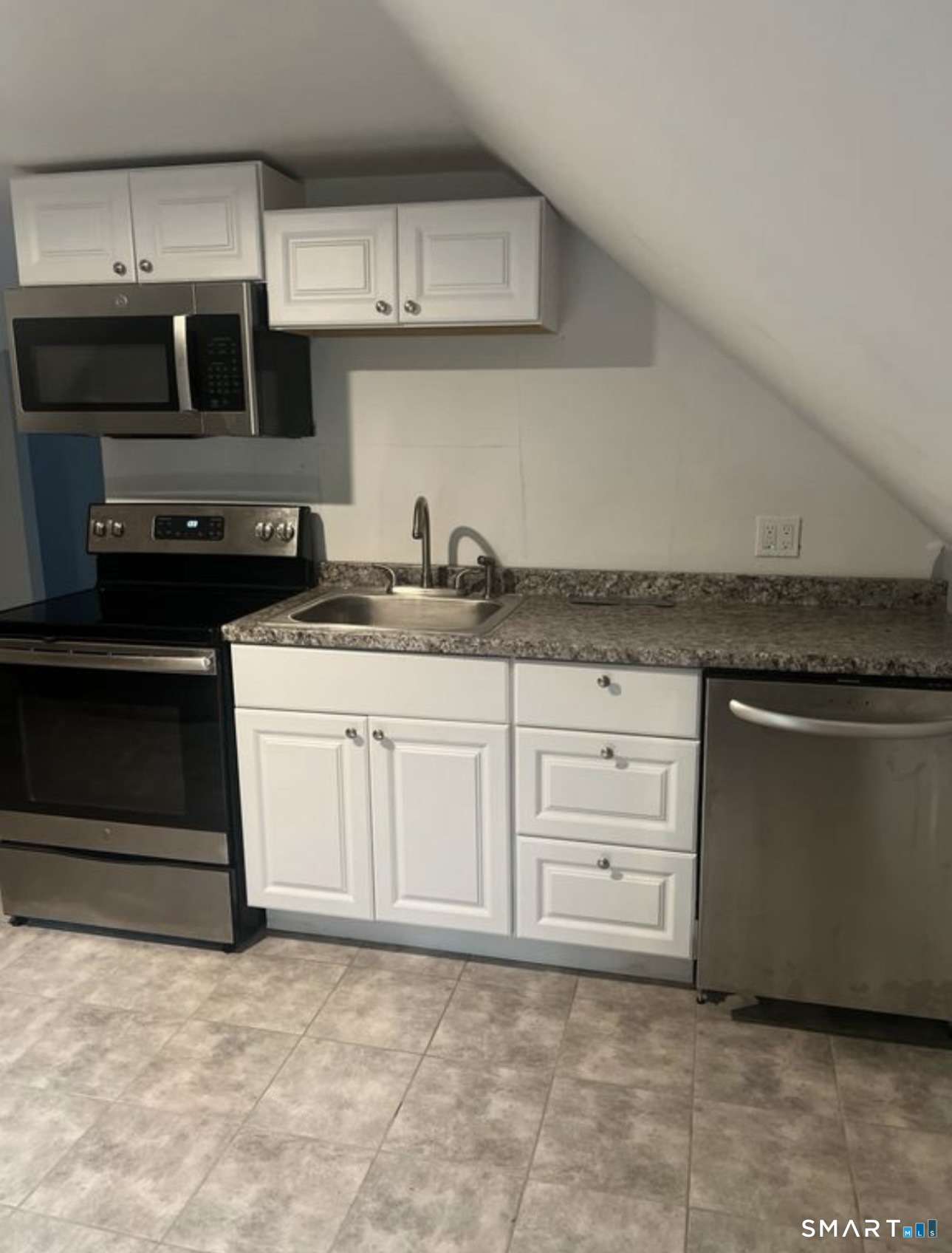 253 Riverside Avenue Torrington, CT 06790 - Photo 3 of 15 a kitchen with granite countertop a stove a sink and cabinets
