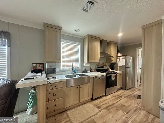 a kitchen with a sink stove and refrigerator