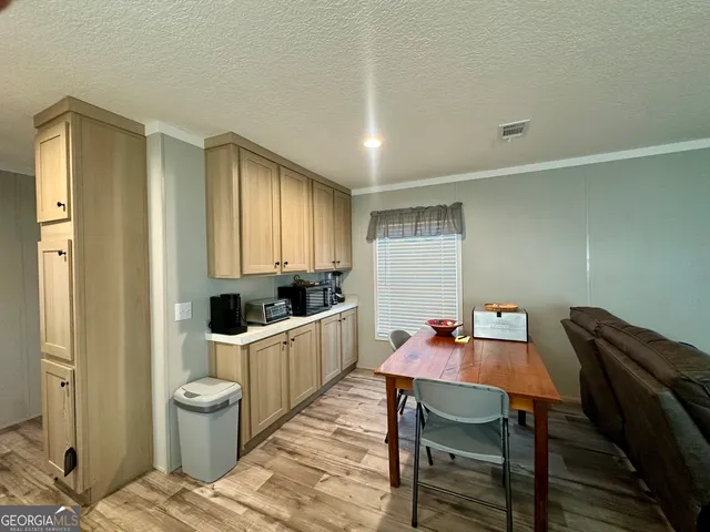 a view of a dining room with furniture and window