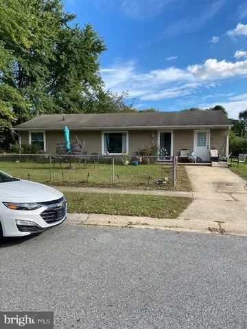 a front view of a house with a yard and porch