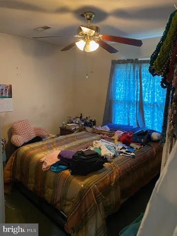 a bedroom with a bed and a mirror