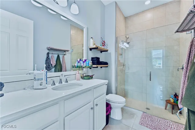 a bathroom with a sink double vanity granite toilet and shower