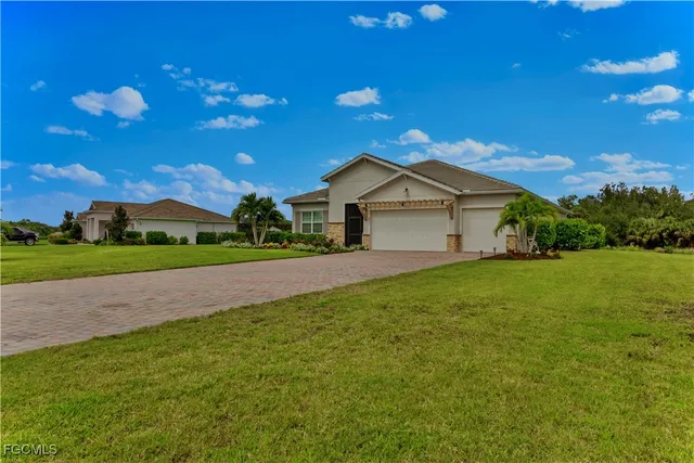a view of an house with backyard space and garden
