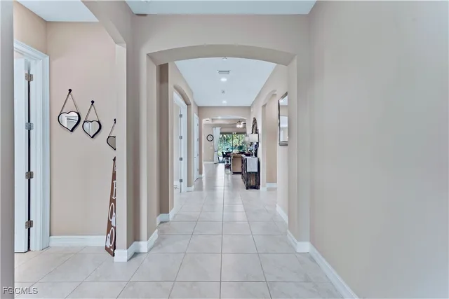 a view of a hallway with a dining table and chairs