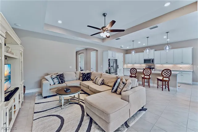 a living room with furniture and kitchen view