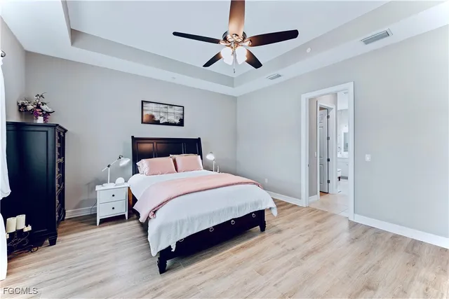 a bedroom with a bed and a chandelier