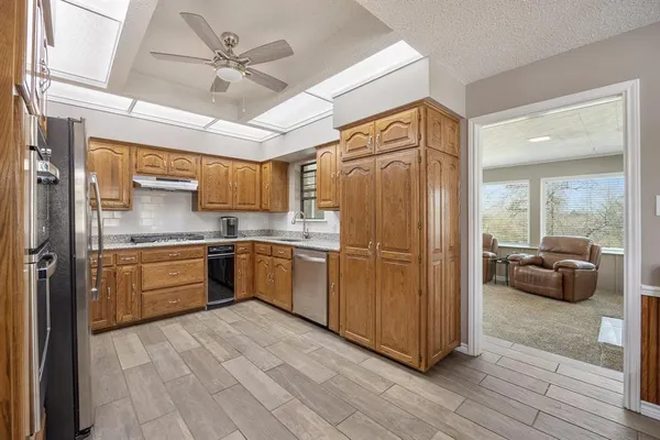 a kitchen with a refrigerator a sink and cabinets