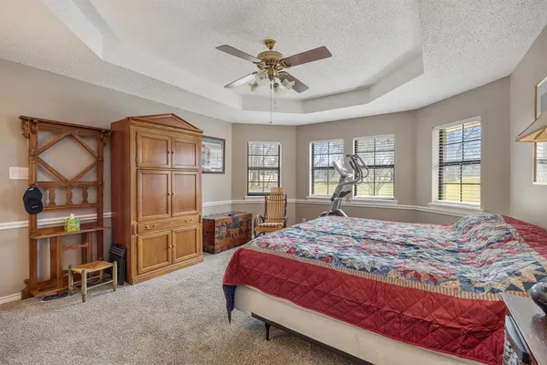 a bedroom with a large bed and a window