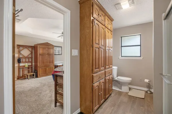 a bathroom with a toilet sink and a mirror