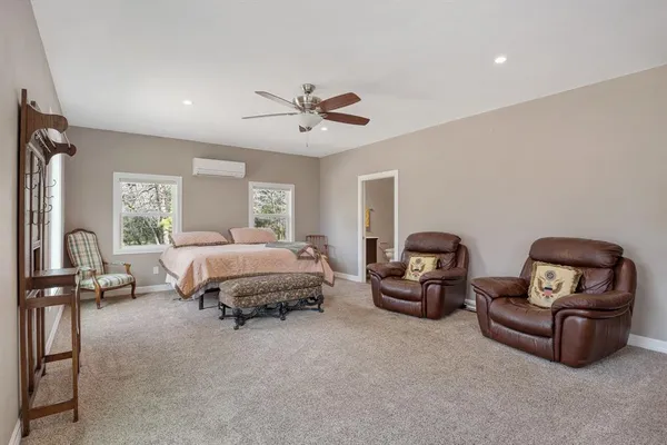 a spacious bedroom with a bed and furniture