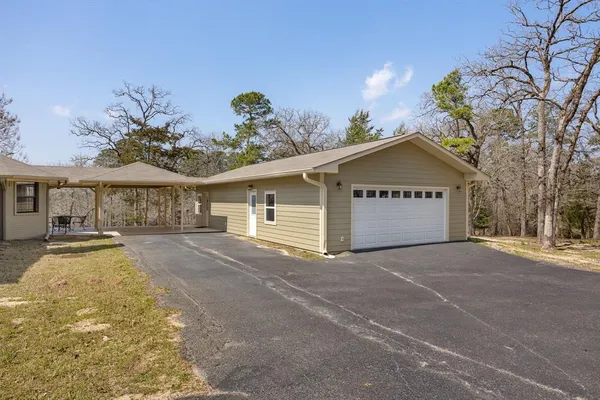 a view of a house with a yard and garage