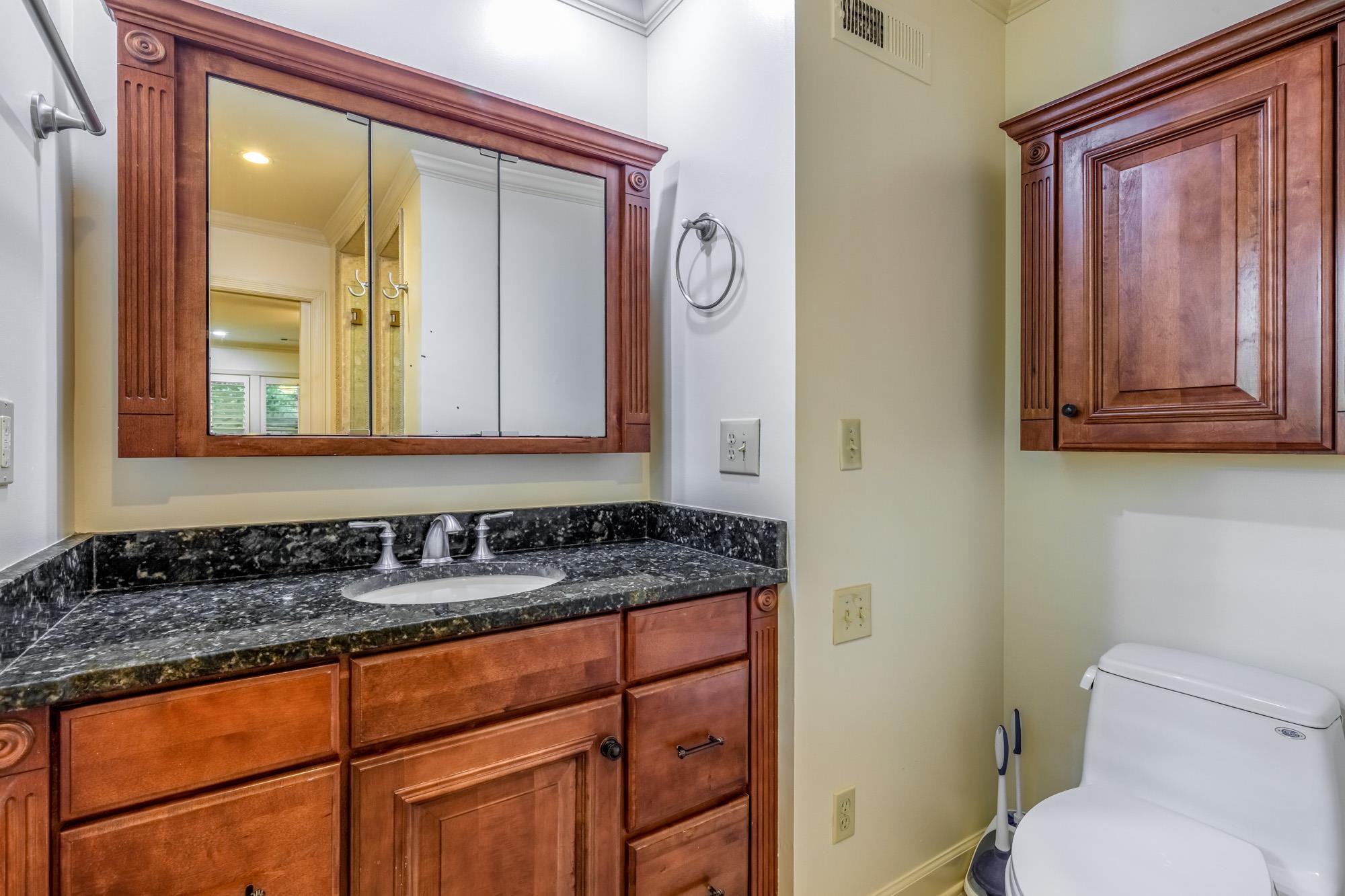 4174 Minden Road Memphis, TN 38117 - Photo 14 of 24 a bathroom with a granite countertop sink mirror vanity and toilet
