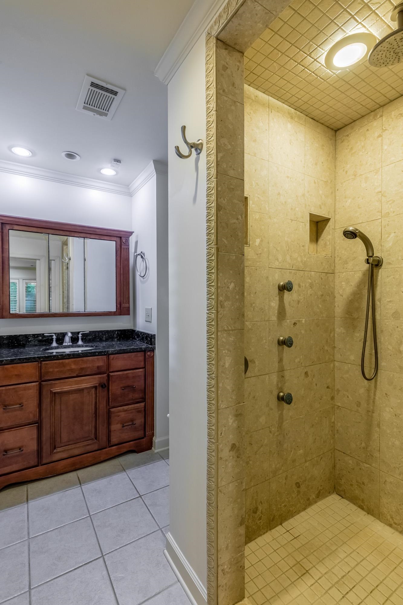 4174 Minden Road Memphis, TN 38117 - Photo 15 of 24 a bathroom with a granite countertop sink a mirror and a shower