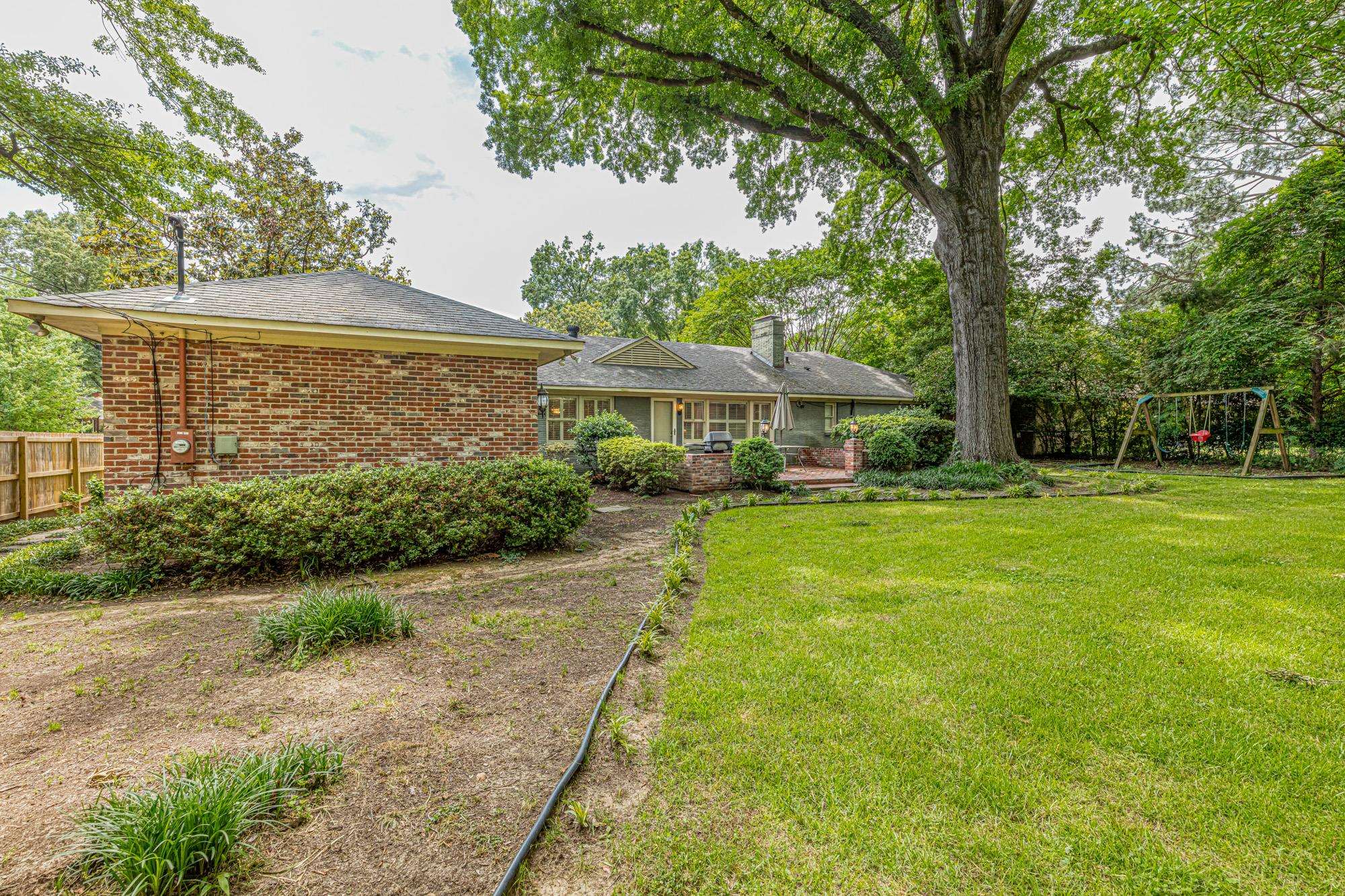 4174 Minden Road Memphis, TN 38117 - Photo 24 of 24 a view of a patio with a table and chairs under an umbrella