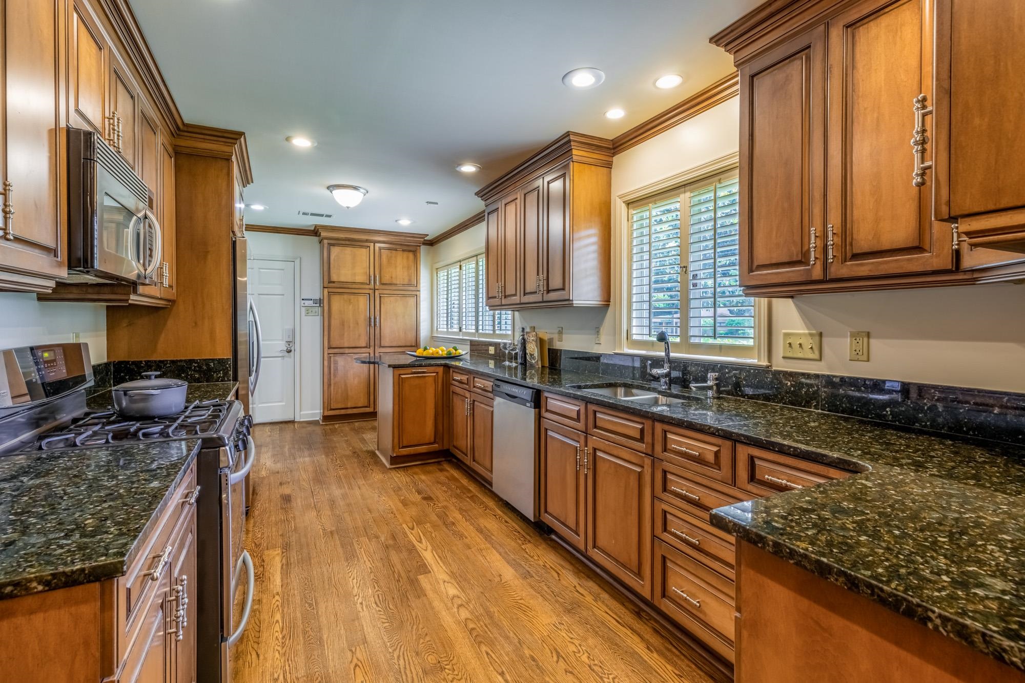 4174 Minden Road Memphis, TN 38117 - Photo 7 of 24 a kitchen with stainless steel appliances granite countertop sink stove top oven and cabinets